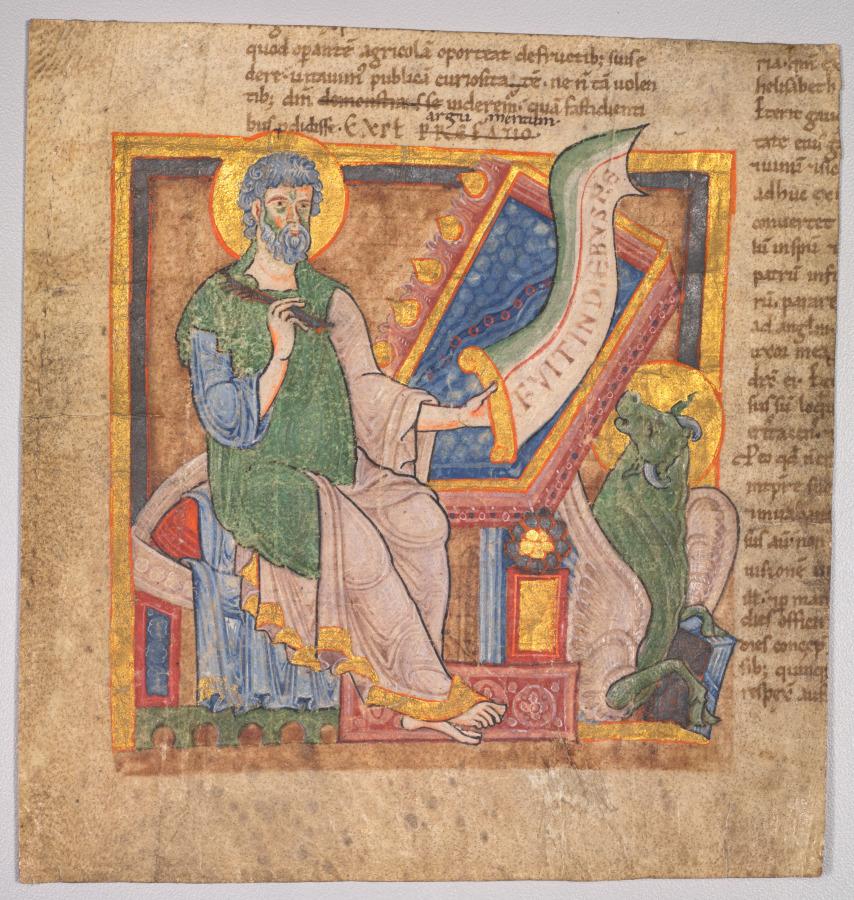 Saint Luke writing beside his winged ox symbol in a manuscript miniature.