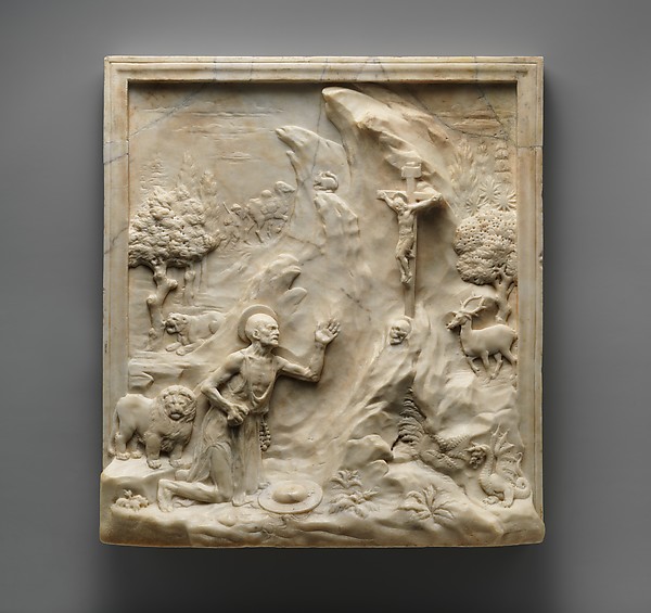 Saint Jerome kneeling in a rocky wilderness with a lion nearby.